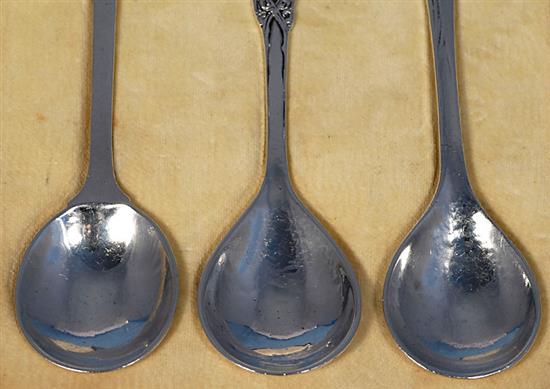 A rare cased set of three George V Arts & Crafts silver spoons, by Omar Ramsden, Length each 162mm total weight 4.8oz/150grms